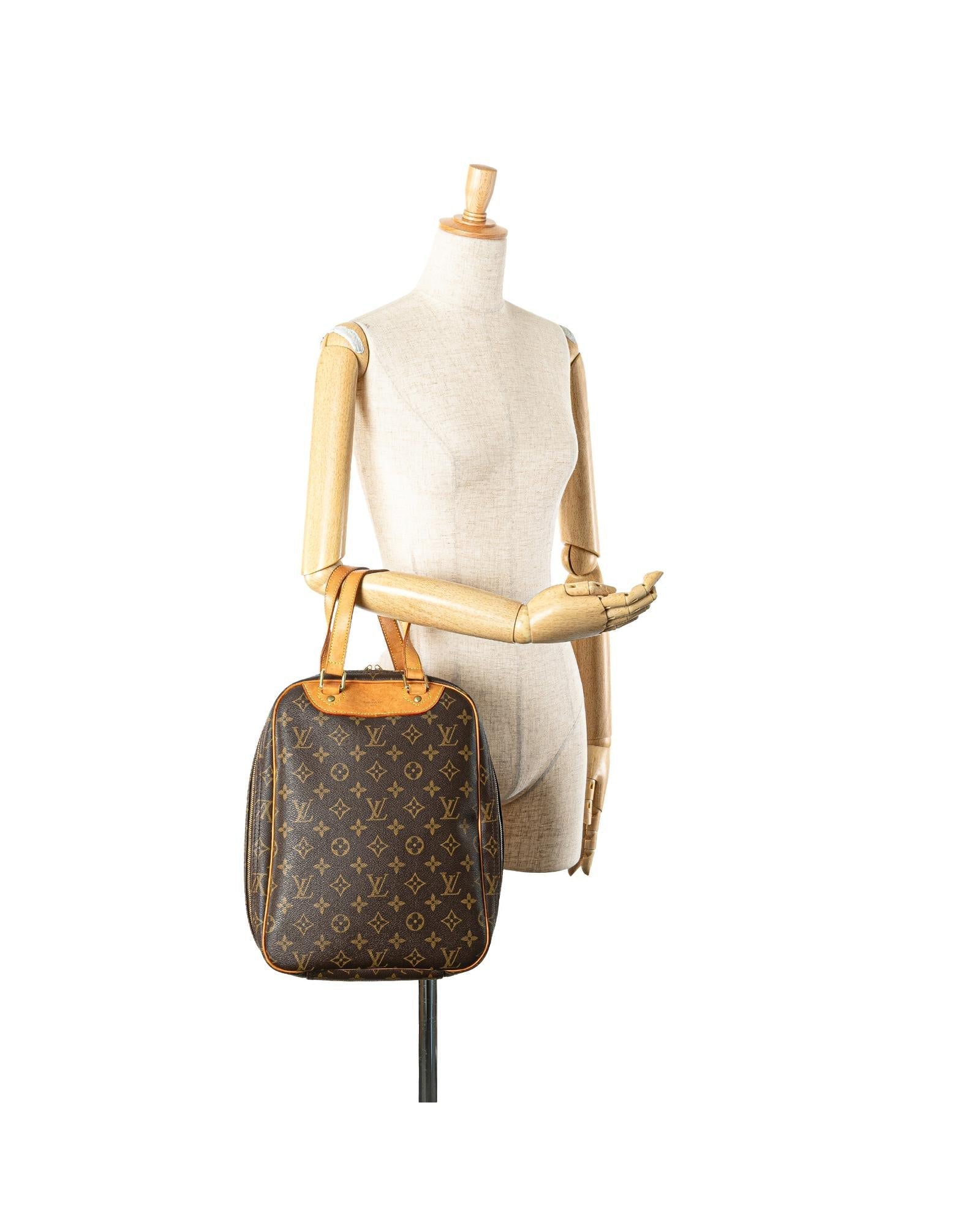 Monogram Canvas Excursion Bag with Vachetta Leather Trim and Zip Closure