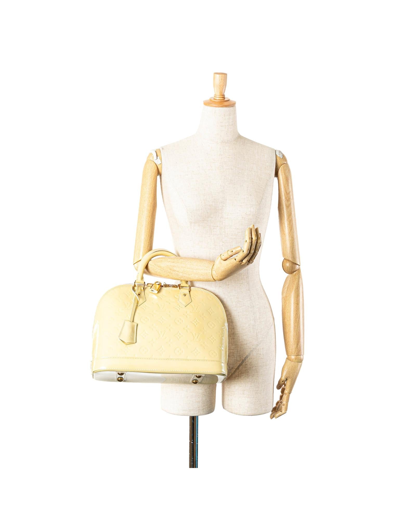 Monogram Vernis Alma PM Handbag with Rolled Handles and Interior Slip Pockets
